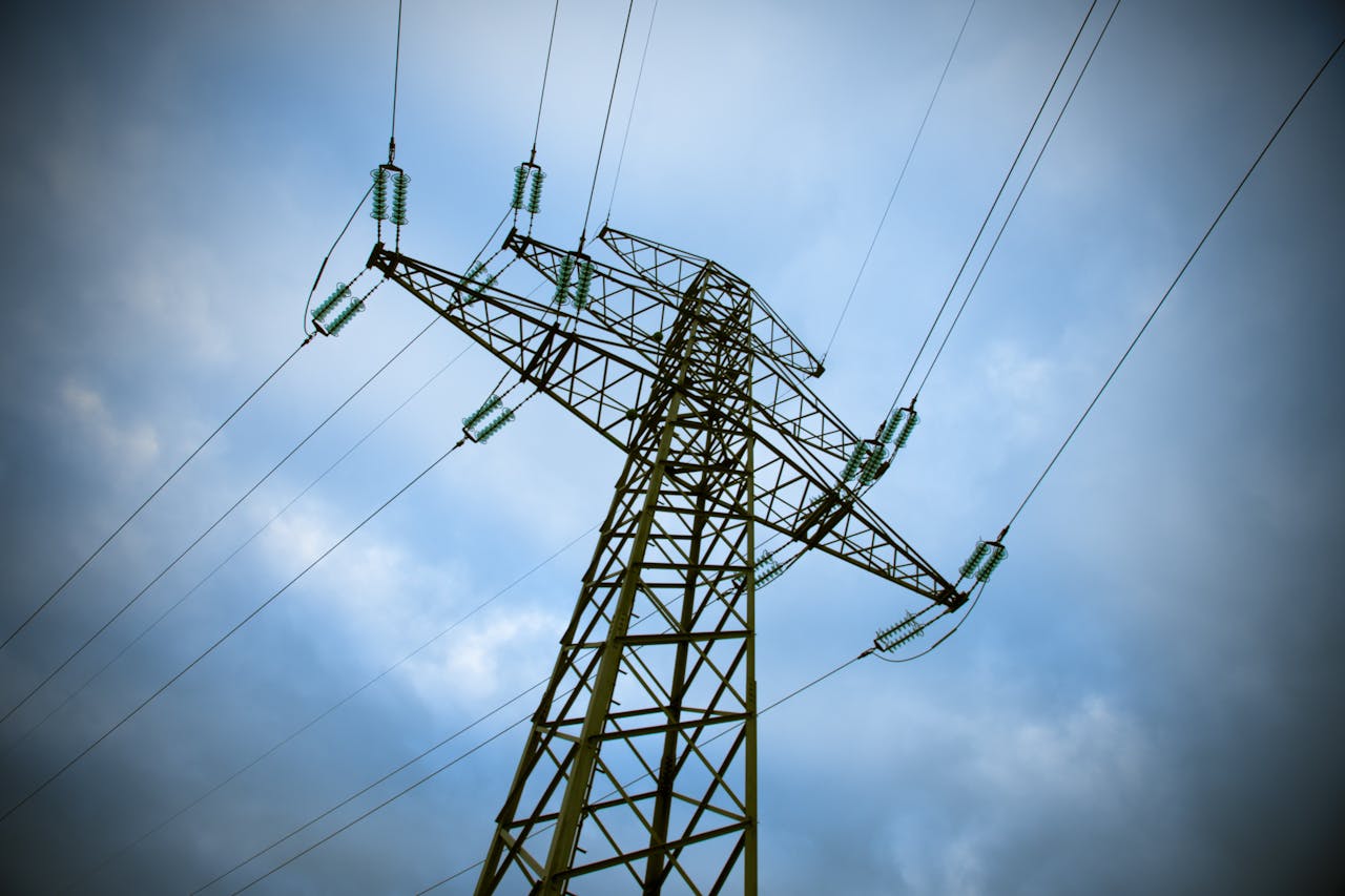 Crafting Captivating Headlines: Your awesome post title goes here A majestic transmission tower stands tall against a cloudy blue sky, showcasing modern electric infrastructure.