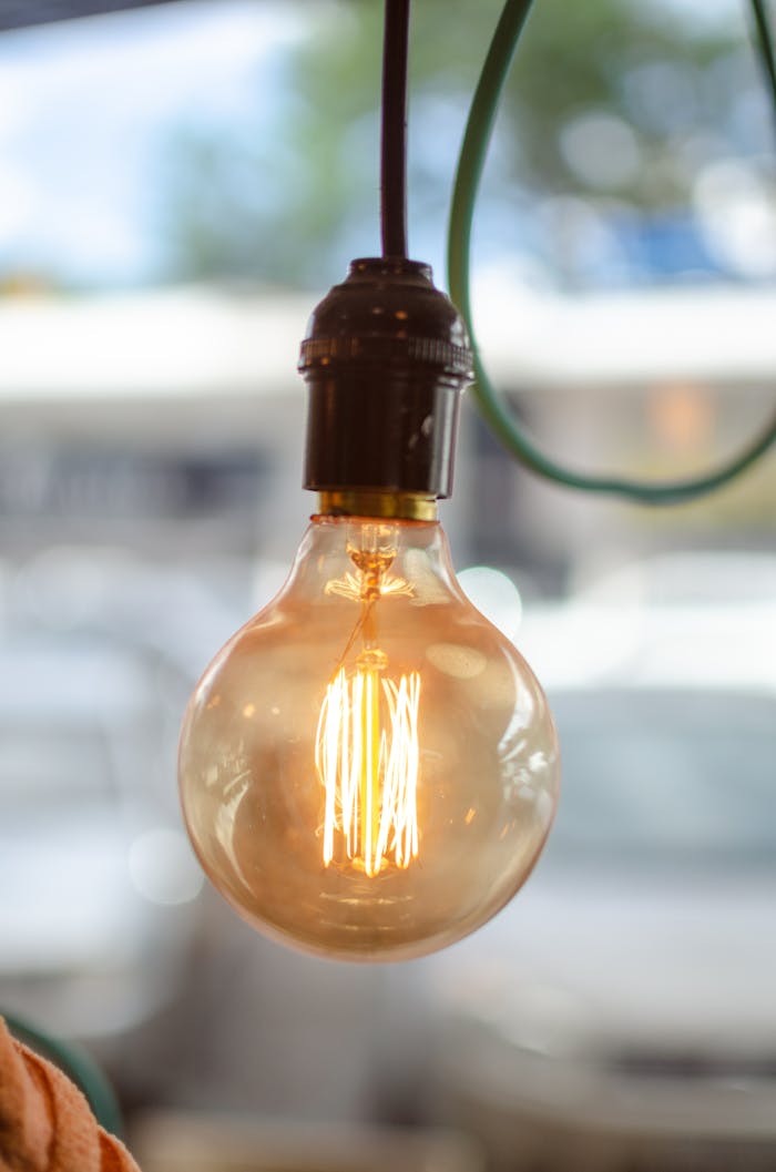 The Art of Drawing Readers In: Your attractive post title goes here Close-up of a glowing light bulb with visible filament, perfect for energy or design concepts.